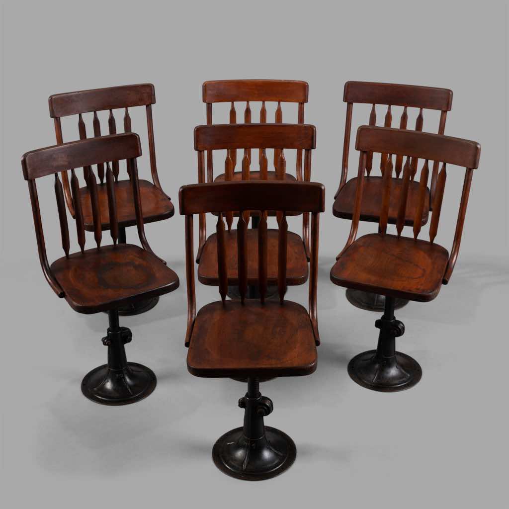 Seven Cast Iron and Wood Ajustable Height Chairs, circa 1895
